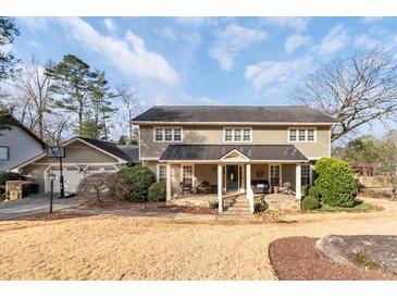 Charming two-story home featuring a welcoming front porch and a spacious three car garage at 343 Woodstone Dr, Marietta, GA 30068