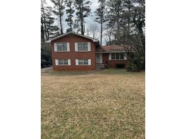 Charming two-story brick home with traditional architecture and a well-maintained front lawn at 1046 Sans Souci Way, Clarkston, GA 30021