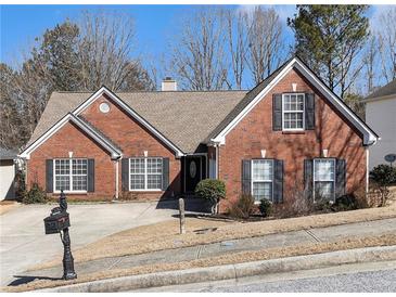 Charming one-story brick home with landscaped front yard and classic black shutters at 1176 Whatley Mill Ln, Lawrenceville, GA 30045