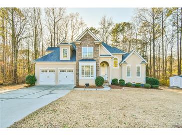 Charming two-story home with a manicured lawn and three-car garage at 2685 Lenora Church Rd, Snellville, GA 30078