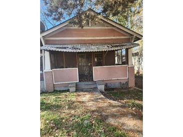 Charming single-story home featuring a covered front porch and vintage architectural details at 750 Alta Pl, Atlanta, GA 30318