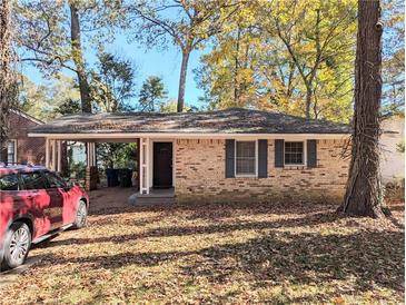 Charming brick home featuring a convenient carport, enhancing curb appeal and providing sheltered parking at 1692 Shirley Sw St, Atlanta, GA 30310