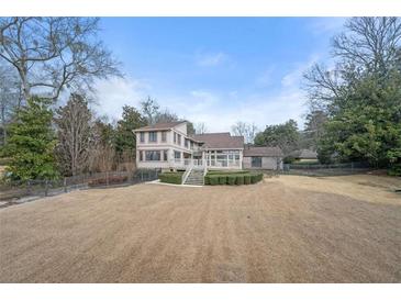 A view of the home's exterior showing the backyard, deck, and staircase at 3167 Bay View Dr, Jonesboro, GA 30236