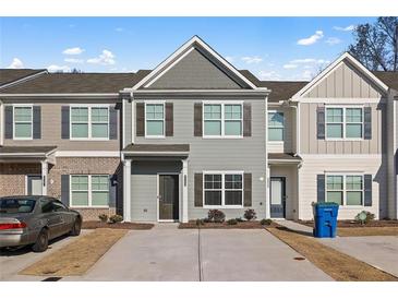 Charming townhome featuring neutral siding, a concrete driveway, and well-maintained landscaping, creating a welcoming curb appeal at 6089 Mallory Rdg, Union City, GA 30291