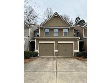 Inviting two-story home with a double garage and neutral-colored siding at 256 Oakview Dr, Canton, GA 30114