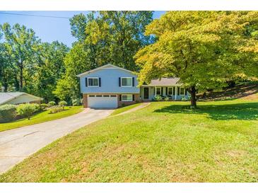 Charming two-story home with a well-maintained lawn and long driveway at 4230 Deerwood Se Pkwy, Smyrna, GA 30082