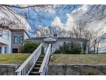 Charming single-story home featuring a stone foundation, grassy yard and inviting walkway at 1340 Bernard Nw St, Atlanta, GA 30314