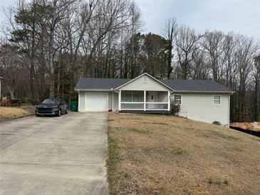Charming single Gathering home with a well-maintained front yard and attached one car garage at 4567 Duncan Dr, Sugar Hill, GA 30518