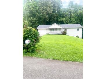 Charming single-story home with a well-maintained lawn and mature trees at 4567 Duncan Dr, Sugar Hill, GA 30518