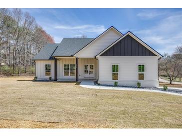 Charming one-story home with white siding, black accents, large front lawn, and a paved walkway to the front door at 1270 Sandhill Hulett Rd, Villa Rica, GA 30180