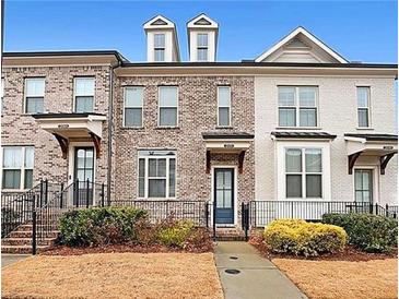 Charming townhome exterior with brick facade, small front yard, and inviting entrance at 2051 Glenview Park Cir, Duluth, GA 30097