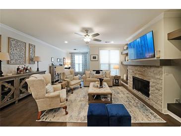 Bright and airy living room with a fireplace, ceiling fan, and lots of natural light at 2051 Glenview Park Cir, Duluth, GA 30097