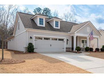 Charming home featuring a two-car garage, dormer windows, manicured lawn, and welcoming front porch at 4901 Pleasantry Nw Way, Acworth, GA 30101