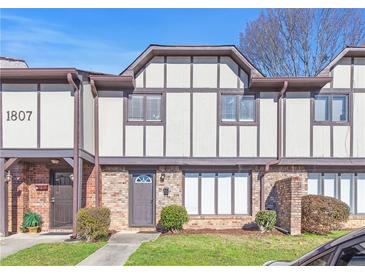 Charming townhome features traditional architecture with brick and siding accents at 1807 Ashborough Cir # G, Marietta, GA 30067