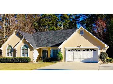 Charming single-story home with a well-manicured lawn and attached two-car garage at 1959 Firelight Ln, Buford, GA 30519