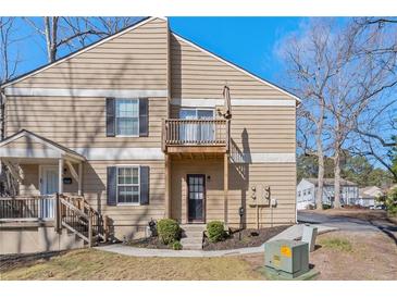 Charming two-story home with a balcony and manicured front yard at 1391 Old Coach Sw Rd, Marietta, GA 30008