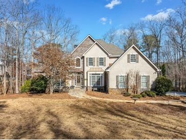 Charming two-story home with stone accents and a well-maintained front yard, perfect for curb appeal at 210 Lawn Market, Sharpsburg, GA 30277