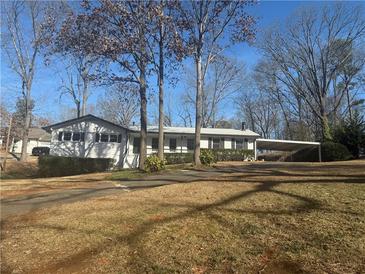 Charming single story home with attached carport and mature trees in front yard at 536 Joann Ave, Austell, GA 30168