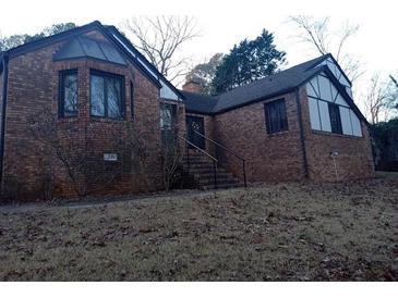 Charming two-story brick home with a quaint entry staircase and unique architectural details at 9031 Thornton Rd, Jonesboro, GA 30236