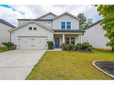 Charming two-story home with white siding, well-manicured lawn, and a cozy front porch at 1935 Azure Grove Ct, Marietta, GA 30008