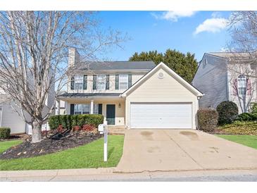 Charming two-story home with manicured lawn, a two-car garage, and inviting curb appeal at 79 Greystone Way, Hiram, GA 30141