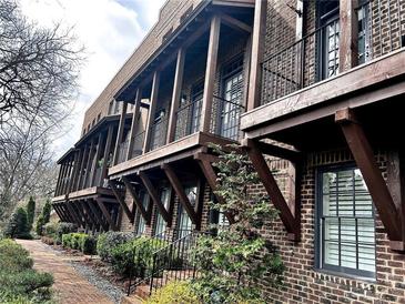 Brick townhomes featuring wooden balconies, providing charming architectural detail at 16 Ramsey St, Roswell, GA 30075