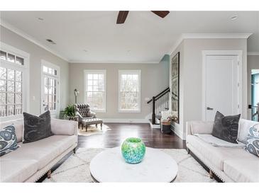 Bright living room with hardwood floors, neutral decor, and large windows at 16 Ramsey St, Roswell, GA 30075