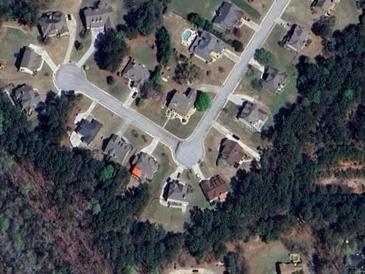 An aerial view of the community with homes nestled near a densely wooded area at 1050 Silver Thorne Dr, Loganville, GA 30052