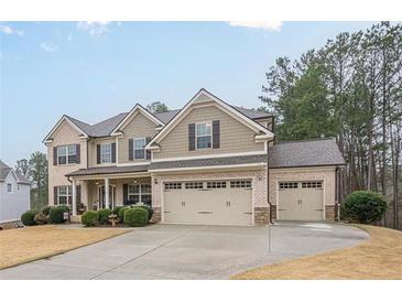 Charming two-story home with brick and siding exterior and a three-car garage at 1050 Silver Thorne Dr, Loganville, GA 30052