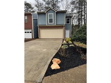 Charming two-story home with a brick-accented garage and newly installed black mulch at 1744 Millview Dr, Marietta, GA 30062