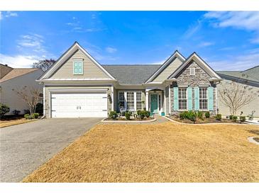 Charming single-story home featuring stone accents, a well-maintained lawn, and an attached garage at 912 Santa Anita Dr, Woodstock, GA 30189