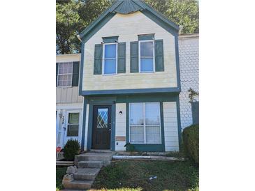 Two-story home with a dark front door and matching trim, enhancing curb appeal at 400 Prince Of Wales, Stone Mountain, GA 30083