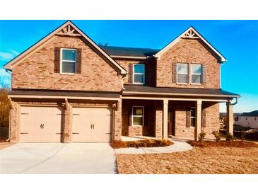 Charming two-story brick home with a two-car garage and well-manicured front yard at 412 Barley Lot 86 Ct, Covington, GA 30014