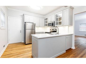 Modern kitchen features stainless steel appliances, white cabinets, and quartz countertops at 430 Lindbergh Ne Dr # M1, Atlanta, GA 30305