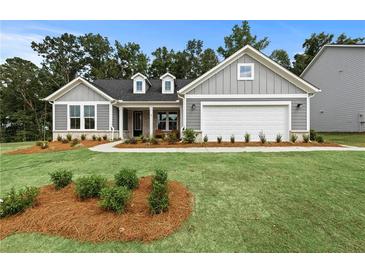 Charming single-Gathering home with manicured lawn and gray siding at 313 Canoe Pl, Villa Rica, GA 30180