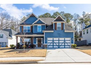 Charming two-story home with a well-manicured lawn and a two-car garage at 117 Pacific Ave, Sharpsburg, GA 30277