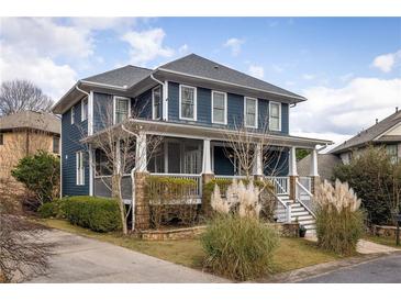 Charming two-story home with a welcoming front porch and beautifully landscaped front yard at 1602 Windsor Walk, Avondale Estates, GA 30002