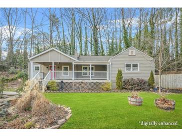 Charming single-story home with a inviting front porch and well-manicured lawn surrounded by mature trees at 437 Westmeath Sw Dr, Atlanta, GA 30310