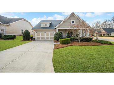 Charming home featuring a manicured lawn, two-car garage, and inviting curb appeal at 164 Owens Farm Ln, Woodstock, GA 30188