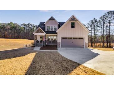 Charming two-story home with a covered front porch, attached garage, and neutral siding at 1721 Mcgarity Rd, Temple, GA 30179