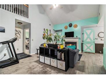 Cozy living room with a fireplace, high ceilings and charming dutch door at 11765 Fairway Overlook, Fayetteville, GA 30215