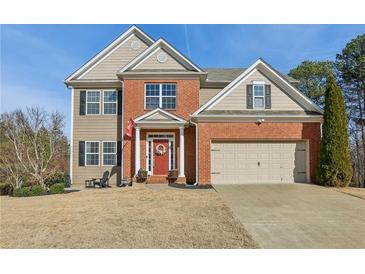 Exterior elevation showing a 2-story brick and tan home with an attached 2-car garage at 5305 Redfield Way, Cumming, GA 30028