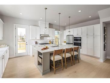 Bright kitchen features a large center island with seating, modern appliances, and ample cabinet space at 2520 Mountain Ash Se Ln # 109, Smyrna, GA 30080