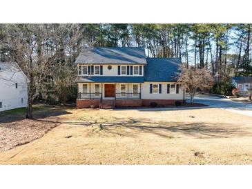 Charming two-story home with a well-maintained lawn and mature trees at 857 Winding Trl, Lawrenceville, GA 30046
