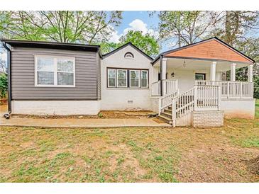 Charming home featuring a quaint covered porch, gray siding and freshly painted white brick at 2769 Glenwood Se Ave, Atlanta, GA 30317