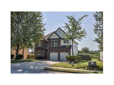 Charming two-story home with a two-car garage and well-maintained landscaping at 907 Southfork Dr, Loganville, GA 30052