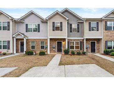 Charming townhome with a well-maintained front yard and neutral siding at 6040 Oakley Rd, Union City, GA 30291