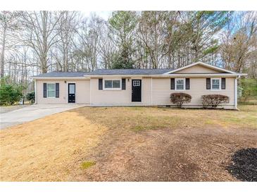 Charming ranch-style home with a well-maintained lawn and inviting curb appeal at 8673 Chestnut Ln, Lithia Springs, GA 30122