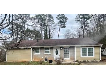 Charming single-story home with a brick and tan exterior and well-maintained front yard at 96 Sir Scott Ct, Lawrenceville, GA 30044