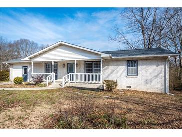 Charming single-story brick home with a covered front porch and well-maintained yard at 202 Porter Ln, Jonesboro, GA 30236